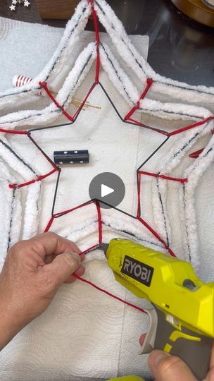 Dollar Tree Star Spangled Patriotic DIY Door Wreath | Love patriotic crafts? This Dollar Tree wire wreath comes to life with just a few supplies! This is perfect for a coffee bar or used as table decor. How... | By Southern Crossroads Creations LLC | Hey, guys. This is Vicky with
Southern Crossroads Creation. We are going to make a 3D star
wreath tonight. So, the form, the star form, the wire form
came from Dollar Tree and this yarn came from Hobby Lobby.
This is one of the the yarns that I absolutely love and you
can usually catch it on sale. Okay and then what you're
going to do, these little pink finger protectors are are a
must for this project because you're going to use the hot
glue in really you know, close proximity of your fingers and
you're going to push the yarn over the wire fo Dollar Tree Wire Form Crafts, Dollar Tree Wire Star Wreath Ideas, Wire Star Wreath Ideas, Star Wire Wreath Form Ideas, Star Wreath Ideas Diy, Star Wreath Form Ideas, Dollar Tree Star Wreath Form Ideas, Diy Star Wreath, Star Wreath Ideas