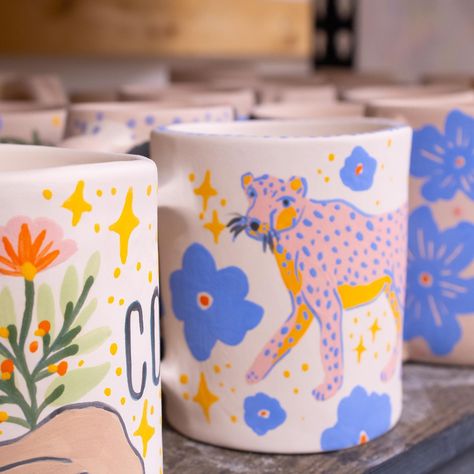 The first batch of bisque mugs is out of the kiln and here’s some snippets of their designs. They still need to be glazed so I won’t spoil the surprise but I’m really excited about these babies 🌸💕☕️✨ #potterylife #potterystudio #mugs #mugsofinstagram #coffeemug #potterylife #handmadeceramics #handmadeceramic #underglaze Paint Plant Pot Ideas, Mug Art Paint, Ceramic Painting Mug, Diy Ceramic Painting, Pottery Art Painting, Pottery Painting Inspiration, Underglaze Painting On Pottery, Underglaze Pottery, Mug Design Ideas