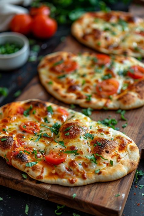 Three freshly baked naan flatbreads topped with melted cheese, cherry tomatoes, and fresh herbs on a wooden board. Pizza Using Naan Bread, Air Fryer Bagel Pizza, Stonefire Naan Recipes, Naan Pizza Oven, Naan Bread Pizza Air Fryer, Nan Bread Meal Ideas, Nan Bread Ideas, Air Fryer Naan Pizza, Naan Bread Ideas