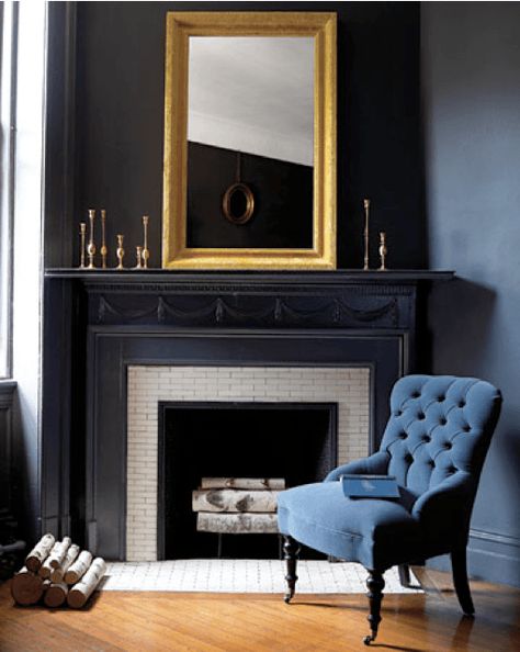 black-fireplace-mantels | love this smart sexy vignette and fireplace via Martha Stewart | love the dark walls with the gold mirror accent and blue velvet occasional chair Navy And Black Interior, Navy Blue Fireplace Mantel, Navy Fireplace Mantel, Black And Gold Fireplace, Dark Blue Fireplace, Navy Fireplace, Blue Mantel, Painting Fireplace, Blue Fireplace