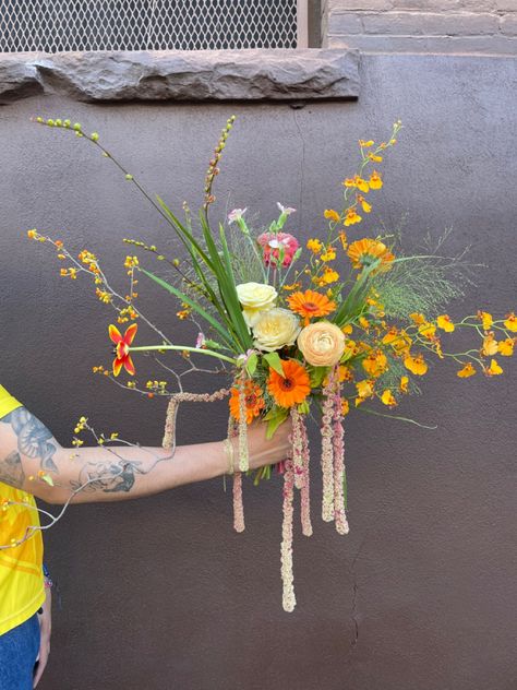 Arm holding out a bouquet of yellow, tan, nude and orange flowers Amaranth Bouquet, Amaranthus Bouquet, Oceanside Wedding, Nyc Florist, Emily Scott, Globe Amaranth, Hand Tied Bouquet, Amaranth, Wedding Mood