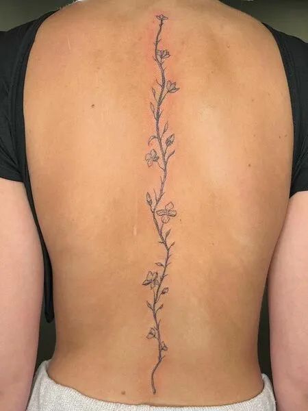 Cherry Blossom Spine Tattoo Flower Vine Tattoo On Back, Back Tats Women Cherry Blossom, Flower Vine Tattoo Down Spine, Flowers Up Spine Tattoo, Simply Spine Tattoo, Bottom Spine Tattoo, Petite Spine Tattoos, Flower Vine Tattoos Spine, Flower Vine Spine Tattoos For Women