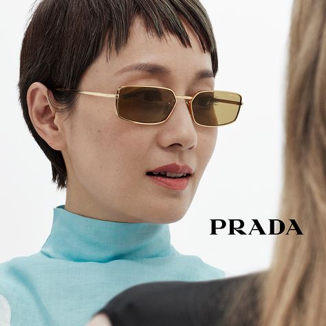 A contemporary approach defines Prada metal sunglasses blending refined details and light silhouettes. Re Edition Prada, Prada Glasses, Prada Re Edition, Ballerina Slippers, Sunglasses Women Designer, Luggage Bags Travel, Prada Eyewear, Denim T Shirt, Jogging Suit