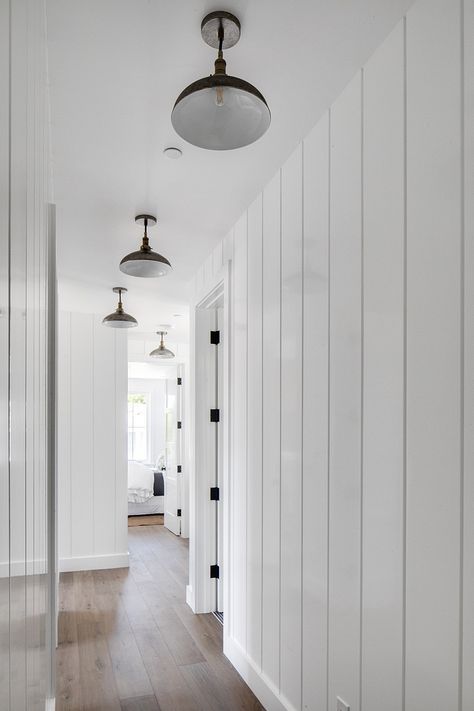 Tongue and groove paneling and barnhouse lighting Painted Vertical Shiplap Walls, Wide Vertical Shiplap, White Vertical Shiplap, California Modern Farmhouse, Shiplap Hallway, Vertical Paneling, Shiplap Farmhouse, Shiplap Paneling, Vertical Shiplap