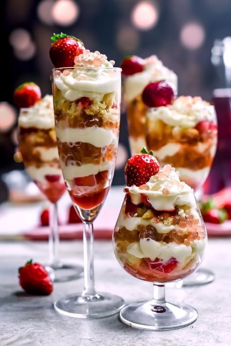 Strawberry Champagne Trifles with Champagne "Caviar". These layered desserts feature strawberry jam, crushed ladyfingers, champagne-soaked strawberries, an easy mascarpone cream, and gelatin strawberry-champagne spheres that are just as fun to make as they are to eat. All together, the trifles make for the perfect New Years Eve or Valentines' Day dessert.  | hostthetoast.com Dessert Trifle, Layered Desserts, Strawberry Champagne, Strawberry Jam, Trifle, Christmas Desserts, Mini Cheesecake, Fireworks, Strawberries