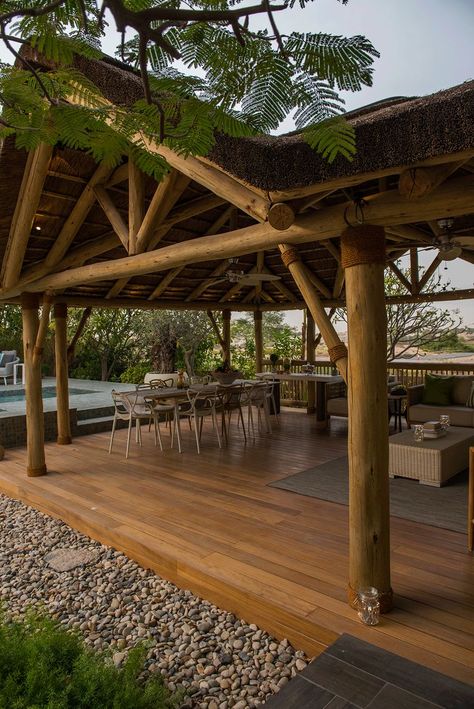 A gabled roof creates an open entrance to your gazebo, adding an enhanced aesthetic appeal to your structure. Green Roof Pavilion, Bamboo Roof Structure, Thatched Roof Gazebo, Thatch Roof Architecture, Bali Huts Gazebo, Open Gazebo, Event Space Design, Dreams Resorts, Garden Gazebo