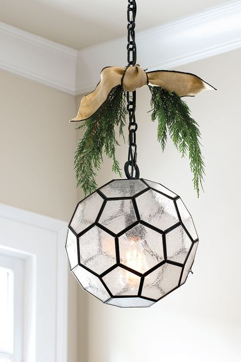 Pendant light with sprigs of greenery and ribbon Ribbon On Pendant Lights, Greenery On Pendant Lights, Decorating Light Fixtures For Christmas, Christmas Pendant Light Decor, Light Fixture Christmas Decor, Decorate Chandelier For Christmas, Christmas Chandelier Ideas, Decorate Chandelier, Farmhouse Addition