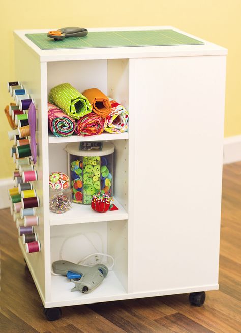 Arrow Cabinets Storage Cube has a durable design with composite body construction and a white mar resistant melamine laminate that will last a lifetime Each side of your four - sided Storage Cube offers storage and organization for all sorts of sewing and crafting accessories You’ll find plenty of storage with three adjustable shelves on one side while the opposite side has one shelf dedicated to 18 thread spindles and two more storage shelves Spin your Cube around to reveal 42 removable thread and bobbin holders with varying lengths to hold thread, bobbins, scissors and any other craft accessory allowing you to customize to your needs The last side of your Storage Cube features two rods for hanging and storing ribbon, yarn or embroidery interfacing Plus behind the rods is 7 - inch of more Crafting Storage, Craft Shelves, Sewing Room Furniture, Cube Storage Unit, Cube Table, Sewing Storage, Storage Cube, Corner Storage, Sewing Rooms