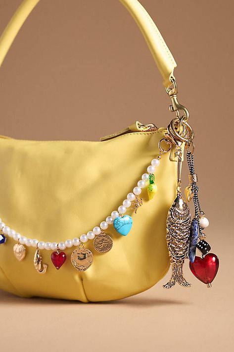 Charming new-trend alert: jewelry for your bag, featuring an antique-inspired brass fish. | Antique Fish Bag Charm by Anthropologie in Gold, Women's, Brass Aesthic Things To Buy, Jelly Cat Bag Charm On Bag, Hello Kitty Bag Charm, Bag Charm Trend, Charm Bag Crochet, Unique Accessories Fashion, Bead Bag Charm, 2024 Jewelry Trends Women, Purse Charms Aesthetic