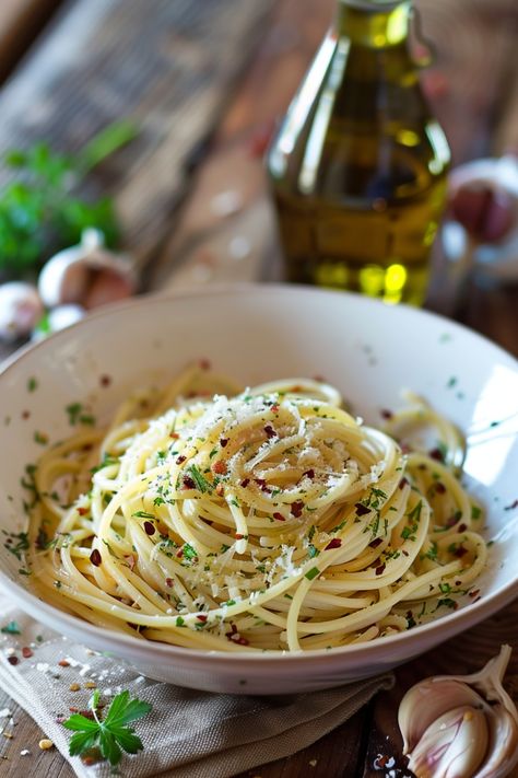 Enjoy the simple yet flavorful Spaghetti Aglio e Olio, a classic Italian dish made with just a few ingredients like garlic, olive oil, and red pepper flakes. This quick and easy recipe is perfect for busy weeknights when you want a satisfying meal without much effort. Serve with a sprinkle of fresh parsley and grated Parmesan cheese for an extra burst of flavor. Treat yourself to this traditional pasta dish that's sure to become a favorite in your repertoire of go-to recipes. Pasta With Parsley, Olive Oil Pasta Recipes, Oil Pasta Recipes, Spaghetti Sides Dishes, Authentic Spaghetti, Garlic Pasta Recipe, Aglio E Olio Recipe, Garnish Ideas, Spaghetti Aglio E Olio