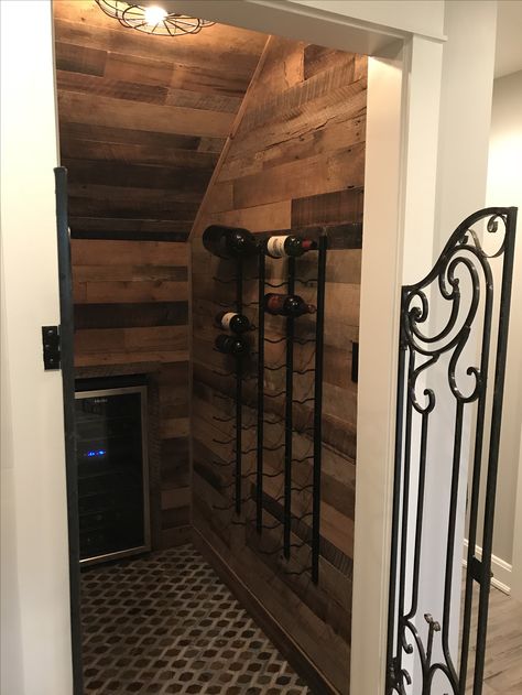 wine saloon, under stairs wine closet, rod iron shutters as door Under The Stairs Wine Room, Wine Bar Under Staircase, Under Stairs Bourbon Storage, Under The Stairs Wine Cellar, Diy Wine Cellar Closet, Bourbon Closet, Wine Closet Under Stairs, Under Stairs Wine, Stair Idea