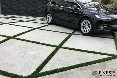 Artificial turf inlays elevate this concrete driveway installed by Genesis Stoneworks Grass Concrete Driveway, Concrete Turf Driveway, Driveway Grass Pavers, Driveway With Grass In Between, Turf Driveway, Concrete Paver Driveway, Landscape Flooring, Yard Pavers, Grass Pavers Driveway