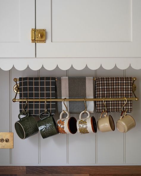 I was setting up my coffee corner for the season & couldn’t help but photograph my mug rail in all its autumnal glory! I love swapping out my mugs & tea towels to add some warmth to the kitchen. It’s all in the details 🤎 *To shop the tea towels, scalloped trim & similar rails + hooks, check out my stories or click the link in my bio #fallkitcheninspo #facebookmarketplace #cottagekitcheninspo #newbuildkitchen #autumncoffeecorner #cljsquad #stillsunday #thriftedhome #coffeecorner #fallkitchen... Hanging Mugs In Kitchen, Coffee Cup Hanger, Mug Rack Wall, Mug Hooks, Hanging Mugs, Coffee Mug Display, Thrifted Home, Mug Display, Kitchen Display