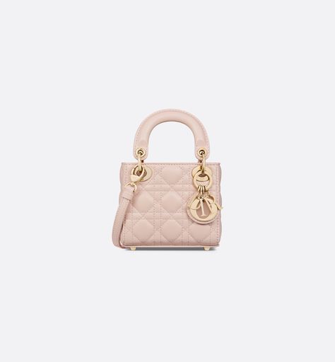 The Lady Dior micro bag embodies the House's vision of elegance and beauty. Crafted in powder pink lambskin with signature Cannage topstitching, its iconic silhouette is embellished with a gold-finish metal D.I.O.R. charm. The Lady Dior bag can accommodate small essential belongings and features an adjustable and removable shoulder strap, allowing it to be carried by hand, worn over the shoulder or crossbody.. Lady Dior Micro Bag, Dior Micro Bag, Lady Dior Micro, Lady Dior Mini, Mini Lady Dior, Micro Bags, Micro Bag, Womens Designer Bags, Christian Dior Couture