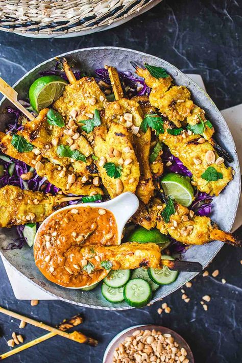 This recipe for Chicken Satay is bursting with authentic Thai flavor! Chicken (or tofu) is bathed in a fragrant marinade of coconut milk and Thai spices, then grilled to perfection and served with a flavorful peanut dipping sauce.  Vegan-adaptable! Thai Chicken Marinade, Satay Tofu, Peanut Sauce Chicken, Thai Chicken Satay, Chicken Satay Recipe, Peanut Dipping Sauce, Tofu Chicken, Thai Spices, Peanut Dipping Sauces