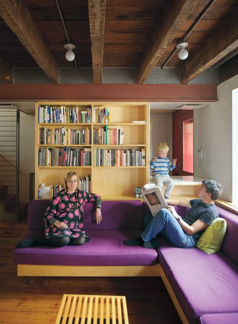 The exposed ceiling beams and inserted steel framing system are visible in the lower level, where Lange and Dixon relax with their son Paul. Fixxer Upper, Basement Ceiling Ideas Cheap, Exposed Basement Ceiling, Basement Ceiling Painted, Laundry Reno, Ceiling Tiles Basement, Basement Ceiling Options, Low Ceiling Basement, Purple Couch