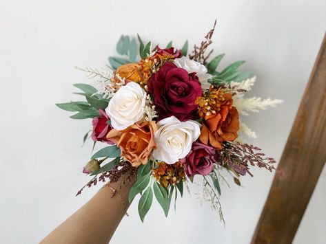 Dimension bridesmaid bouquet - diameter is about 25cm / 10inches bridal bouquet - diameter is about 38cm / 15inches Material silk flowers, faux foliage, etc. Flowers & Foliages rose, eucalyptus, wax flower, pampas, etc. Colors burgundy, ivory white, burnt orange, sage green, etc. * Please kindly note that my shop is based in China, so all the flower works in my shop will be shipped abroad. * White Burgundy Orange Bouquet, Fall Wedding Centerpieces Long Table, Burnt Orange Centerpieces Wedding, Simple Fall Wedding Bouquets, Sage Green And Burnt Orange Wedding, Burgundy And Rust Wedding, Burgundy And Burnt Orange Wedding, Sunset Orange Wedding, Burnt Orange Wedding Flowers