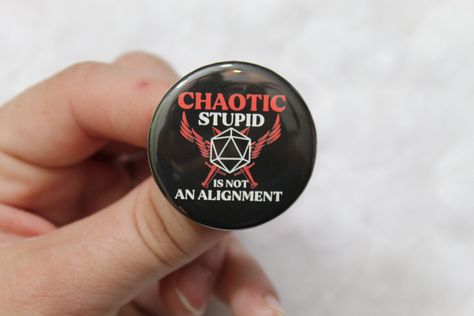 "Nerdy\"Chaotic Stupid Is Not An Alignment\"  inspired button. This pin will make the perfect gift for anyone who enjoys popular role-playing games such as DND, Pathfinder and more!  Perfect for the geek in your life  This button is a  1.5 in circle pin. Perfect for clothes, messenger bags, dice bags, and any other fabric material." Dnd Pins, Pins Enamel, Character Wardrobe, Dice Bags, Funny Buttons, Funny Patches, Dnd Funny, Dnd Ideas, Nerdy Gifts