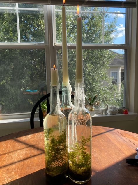 Alcohol Bottle Candle Holder, Candles In Wine Glasses, Witchy Spring Decor, Terrarium With Candles, Wine Candle Holders, Witchy Terrarium, Witchy Candle Holder, Glass Candle Holders Decorating Ideas, Wine Bottle Terrarium