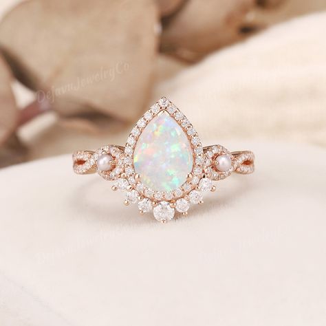 Vintage White Opal Engagement Ring Pearl Engagement Band Rose Gold Vine Ring Infinity Ring Flower Stacking Ring Unique Pear opal Ring Halo ✦ Handmade, high-quality item ✦ Material: SOLID 10K/14K/18K GOLD ( can be made in yellow/white/rose gold ) ✦Engagement ring ✦ Center stone: Lab opal  ✦ Size/Weight: 6*8mm ✦ Cut: Pear Shaped ✦ Side stones: Moissanite, or Natural Diamonds; and natural small pearls ✦ Weight: About 0.386ct  ✦ Color: DEF Color ✦ Cut: Round Shaped ✦ Band Width: Around 1.6mm PRODUCT Gold Opal Ring Engagement, Opal Pearl Ring, Opal And Diamond Engagement Rings, Pear Opal Ring, Engagement Ring Pearl, White Opal Engagement Ring, Vine Ring, Engagement Rings Twisted, Ring Pearl