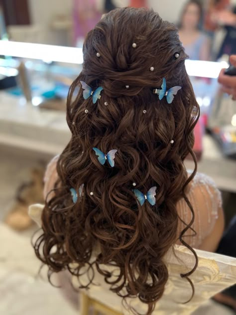 A bridal half open hairstyle with curly hair and hair is decorated with butterfly hair accessories and pearl hair accessories. Hair is highlighted to a soft brown and is tonged with a small tong Cute Hairstyles For Long Hair For Wedding, Prom Hairstyles Butterflies, Hairstyle For My Birthday, Butterfly Hair Styling Ideas, Butterflies In Hair Hairstyles, Hairstyle Design For Wedding, Hair Styles For Prom Long, Butterflies Hairstyles, Hair Styles Open Hair