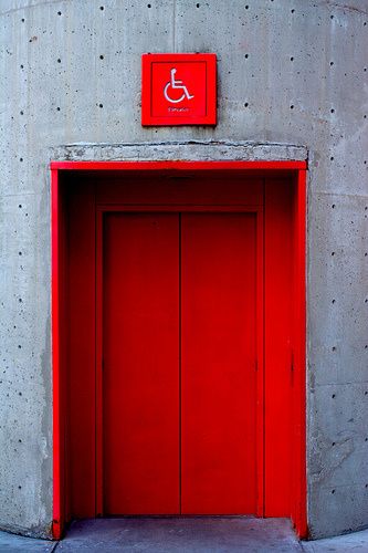 A bright red elevator. A great way to show people where an elevator is at a building. User Centric Design and Inclusivity Elevator Lobby Design, Architectural Thesis, Elevator Lobby, User Centered Design, Concrete Interiors, Elevator Design, Signage System, Lift Design, The Passenger