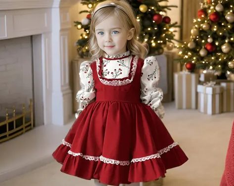 cute little girl with blonde hair is wearing a long sleeved red christmas dress with white shirt detail and posing with innocent smile. Toddler Girls Christmas Dress, Christmas Dress Baby Girl, Girls Christmas Dress Pattern, Christmas Outfit For Kids, Christmas Dress For Kids, Christmas Theme Dress, Toddler Girl Christmas Dress, Christmas Red Dress, Simple And Elegant Dress