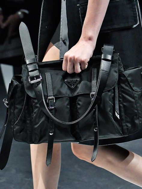 The nylon bag has made a comeback in a big way. From Prada's iconic design to the high-street versions, we've selected the best. Big Prada Bag, Prada Nylon Bag Street Style, Prada Nylon Outfit, Small Bag Outfit, Prada Book, Prada Bag Outfit, Prada Bag Black, Prada Nylon Bag, Shoulder Bag Outfit