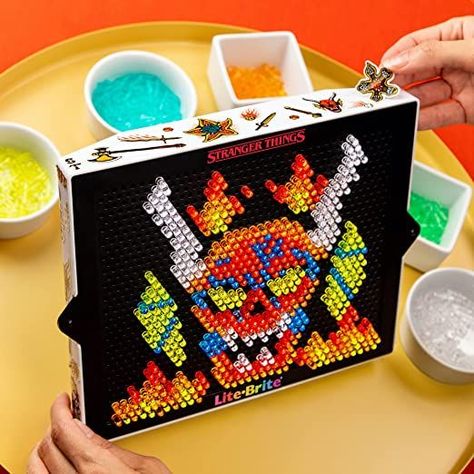 LITE-BRITE x STRANGER THINGS Your favorite retro toy teams up with Stranger Things! Create art with light with this high-definition Stranger Things Special Edition Demogorgon Hunters Lite-Brite set in retro packaging for fans 14 years old and up to collect and display! Also includes, Stranger Things stickers to customize your unit frame and a branded pouch to carry and store your pegs in! Hd Templates, Lite Brite Designs, Stranger Things Stickers, Art With Light, Retro Packaging, Hd Design, Lite Brite, Retro Toys, Storage Pouch