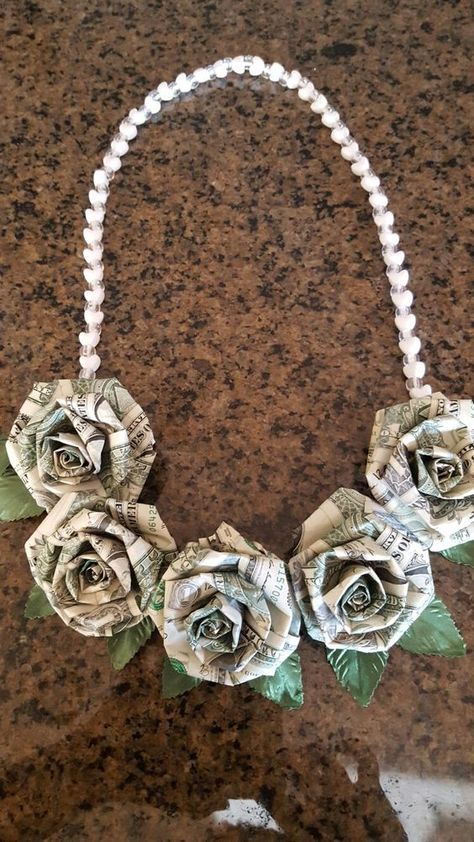 Money origami dollar roses lei Dollar Rose, Money Lei Diy, Money Folding, Folded Money, Origami Dollar, Lei Ideas, Graduation Leis Diy, Money Necklace, Origami Money