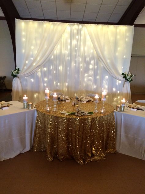 Gold sequin sweetheart table 50th Anniversary Main Table, Back Drop For Wedding Receptions, Gold Head Table Wedding, Gold Sweetheart Table Wedding, Head Table Wedding Decorations Simple, Wedding Backdrop Reception Head Table, Gold Sequin Table Runner Wedding, Gold Sweetheart Table, Wedding Backdrop Reception