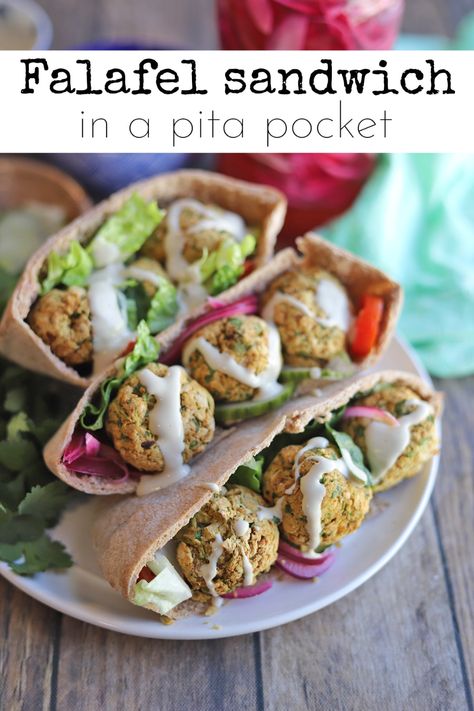 This cozy & flavorful falafel sandwich is packed with cucumbers, lettuce, pickled onions, and tomatoes in warm pita bread. It’s finished with a tangy lemon tahini dressing. This dish is super satiating but not too heavy, thanks to baked or air fried falafel. #falafel #falafelsandwich #vegansandwich #pitapockets Falafel Waffle, Air Fryer Tortilla, Vegan Flatbread, Falafel Mix, Falafel Pita, Falafel Sandwich, Pita Bread Recipe, Vegan Tzatziki, Vegan Feta Cheese