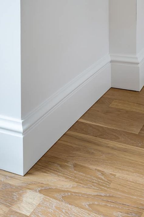 Baseboards are the unsung heroes of home design, offering both protection and a polished look to the walls they adorn. Selecting the right size is essential for the overall harmony of your room's design. Standard baseboard sizes can vary, and choosing the appropriate one can enhance the stature and flow of your space. This guide aims to demystify the standard dimensions of baseboards to help you make the best choice for your home. Types Of Baseboards And Trim, Trim For House Baseboards, White Wall Baseboard Color, Trim Styles Baseboard, Different Baseboard Styles, White Walls White Baseboards, Baseboards Without Quarter Round, Extra Tall Baseboards, Classic Baseboards