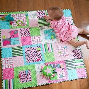 Add fun and fuction to a stroller-size quilt by sewing ribbon and rickrack loops into the blocks. Fat Quarter Sewing Projects, Kids Quilts, Memory Quilts, Fat Quarter Quilt, Diy Bebe, Patchwork Blanket, Childrens Quilts, Baby Quilt Patterns, Baby Sewing Projects