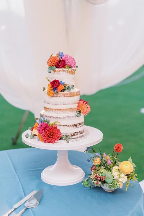 Photography: http://bonniesen.com Wedding Cakes With Bright Flowers, White Cake With Bright Flowers, Wedding Cake No Frosting, End Of Summer Wedding Ideas, Wedding Cake Sunset, Colorful Flower Wedding Cake, Summer Wedding Cake Designs, Bright Floral Wedding Cake, Colorful Floral Wedding Cake