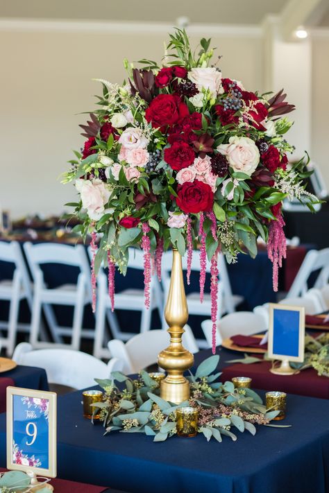 Tall blush, marsala and navy centerpiece with greenery on gold pedestal. Blue Scope Photography Navy Wedding Centerpieces, Valerie Phillips, Navy Centerpieces, Navy And Blush Wedding, Burgundy Wedding Centerpieces, Blush Wedding Centerpieces, Hanging Amaranthus, Navy And Burgundy Wedding, Gold Pedestal