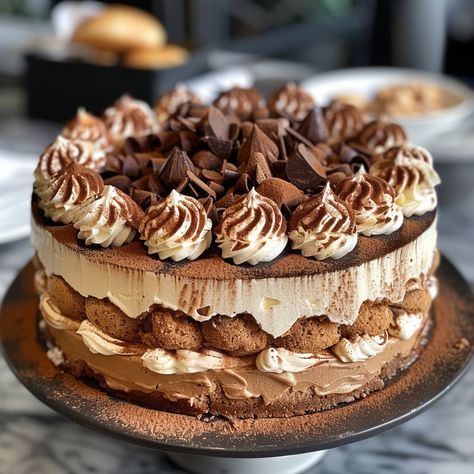 Tiramisu Cake Ingredients: For the Cake: 1 1/2 cups all-purpose flour 1 1/2 tsp baking powder 1/2 tsp salt 1/2 cup unsalted butter, room temperature 1 cup granulated sugar 3 large eggs 1 tsp vanilla extract 1/2 cup whole milk For the Coffee Syrup: 1 cup strong brewed coffee, cooled 2 tbsp sugar 1 tbsp coffee liqueur (optional) For the Mascarpone Filling: 1 1/2 cups mascarpone cheese 1 1/2 cups heavy cream 1/2 cup powdered sugar 1 tsp vanilla extract For the Whipped Cream Topping: 1 cup heavy ... Mascarpone Filling, Whipped Cream Topping, Espresso Recipes, Coffee Liqueur, Tiramisu Cake, Winter Cake, Elegant Desserts, Gourmet Desserts, Coffee Syrup