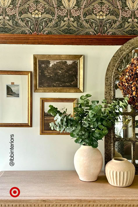 Let’s decode a quick & easy way to set up a modern-vintage corner—pair curved ceramic vases with antique-gold frames to instantly get that classic-moody vibe. Staging Shelves, Cozy Living Room Aesthetic, Academic Office, Target Aesthetic, Window Seat Ideas, Cottage Core Home, Vintage Corner, Whimsical Home, Gold Frames