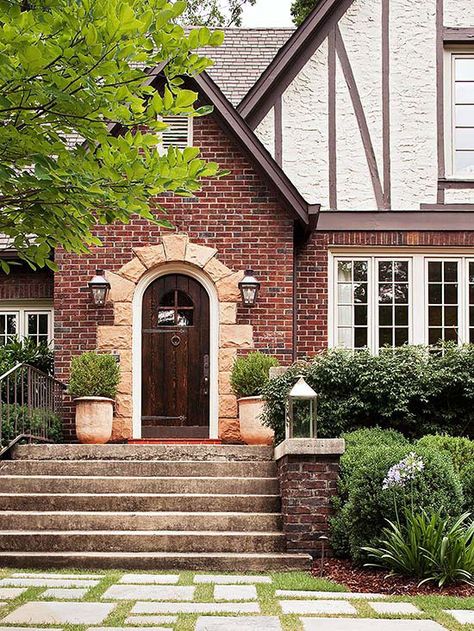 A stone-framed entry provides pleasing contrast to this home's brick exterior: http://www.bhg.com/home-improvement/door/exterior/exterior-doors-and-landscaping/?socsrc=bhgpin060314stoneaccent&page=2 Brick Siding, Elegant Doors, Brick Chimney, Tudor Style Homes, Medieval Houses, Tudor House, Casa Exterior, Exterior Cladding, Tudor Style