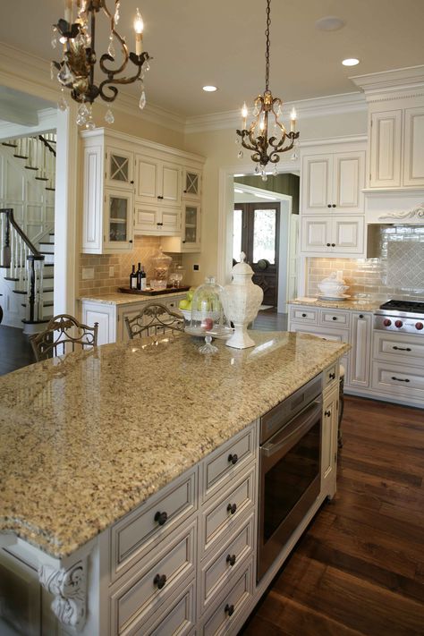 This dark walnut floor contrasts beautifully with the cream tones of this kitchen. Dark Walnut Floors Kitchen, Walnut Floors Kitchen, Kitchen Cabinets Dark Wood, Kitchen Floor Inspiration, Dark Walnut Floors, Floors In Kitchen, Kitchen Backsplash Tile Designs, Dark Wood Kitchen Cabinets, Floor Inspiration