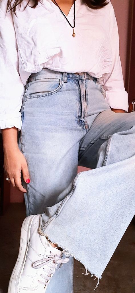 The picture shows an outfit of ice blue wide leg jeans, white short kurta on top with red nails, white sneakers, a locket and a shanti pearl ring Ice Blue Jeans Outfit, Short White Kurti, Kurti And Jeans, Lehenga Skirts, White Kurti, Blue Jeans Outfit, Fusion Wear, Blue Jean Outfits, Short Kurta