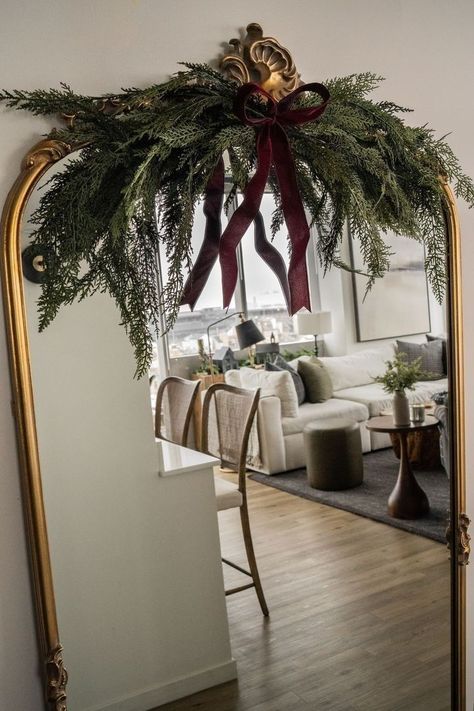 Anthropologie Mirror Christmas Decor, Mirror Swag Garlands, Gold Mirror Christmas Decor, Anthro Mirror Christmas, Christmas Garland Mirror Decor, Christmas Mirror Swag, Garland Mirror Decor, Holiday Decor Entryway, Pine Swags Christmas