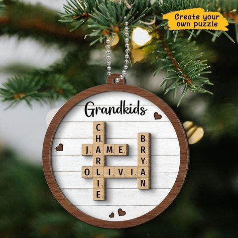 Scrabble Personalized Grandkids Names Christmas Ornaments, Custom Crossword Puzzle Art Personalized 2-Layer Wooden Ornament, Christmas Gift Celebrate the joy of family with our Scrabble Personalized Grandkids' Names Christmas Ornament! This custom 2-layered wooden ornament features a unique crossword puzzle design with the names of your grandkids, making it a thoughtful and personal addition to your holiday decor. It's the perfect Christmas gift for grandparents, combining warmth, family love, a Grandparent Christmas Gift, Scrabble Christmas Ornaments, Scrabble Christmas, Create Your Own Puzzle, Grandparents Christmas Gifts, Grandparents Christmas, Name Christmas Ornaments, Christmas Gifts For Grandma, Family Christmas Ornaments