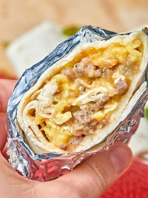 These breakfast burritos are so hearty and filling thanks to the sausage, gooey from the cheese, creamy from those perfectly cooked eggs, and you get your veggies in with the bell peppers! I love that you can take it on the go, because it's wrapped in that ammmmazing tortilla! It's a well-rounded breakfast that'll keep going all morning long! www.showmetheyummy.com #breakfast #burrito #scrambledeggs #makeaheadbreakfast #sausage Easy Make Ahead Breakfast, Make Ahead Breakfast Burritos, Easy Breakfast Burritos, Breakfast Enchiladas, Breakfast For A Crowd, Breakfast Burrito, Burritos Recipe, Sausage And Egg, Breakfast On The Go