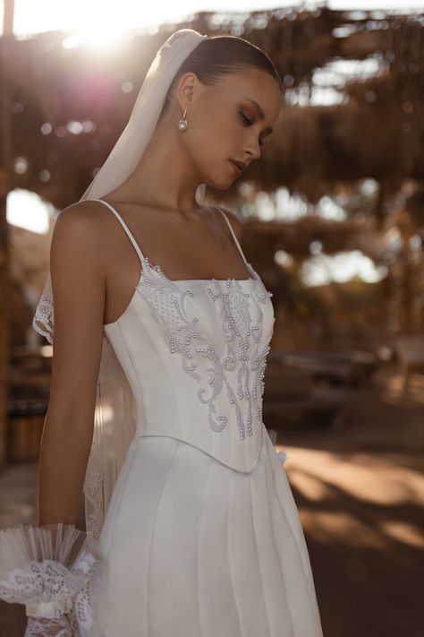 Mini dress with an embroidered top, lace gloves and matching veil. Wedding Corset Top, Lace Mini Corset Dress For Wedding, Elegant Mini Wedding Corset, Wedding Mini-length Corset Dress With Lace Bodice, Sleeveless Wedding Corset With Lace Trim, White Mini Corset Dress With Lace-up Back, Minimalist Wedding Gown, Wedding Corset, Basque Waist