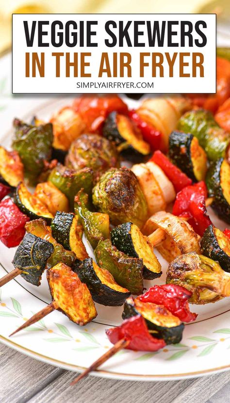 cooked vegetable skewers with zucchini, bell peppers, and other vegetables on plate with text overlay "veggie skewers in the air fryer". Vegetable Kabobs In Air Fryer, Air Fryer Kabobs, Air Fried Veggies, Vegan Kabobs, Air Fryer Vegetable, Marinated Veggies, Roasted Vegetables With Chicken, Greek Chicken Kabobs, Veggie Kebabs