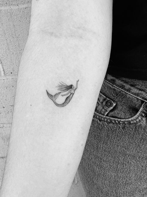 Little dainty single needle tattoo of a mermaid for feminine energy Micro Mermaid Tattoo, Mermaid Fineline Tattoo, Mini Mermaid Tattoo, Dainty Mermaid Tattoo, Mermaid Fine Line Tattoo, Small Mermaid Tattoo Designs, Minimalist Mermaid Tattoo, Tiny Mermaid Tattoo, Fine Line Mermaid Tattoo