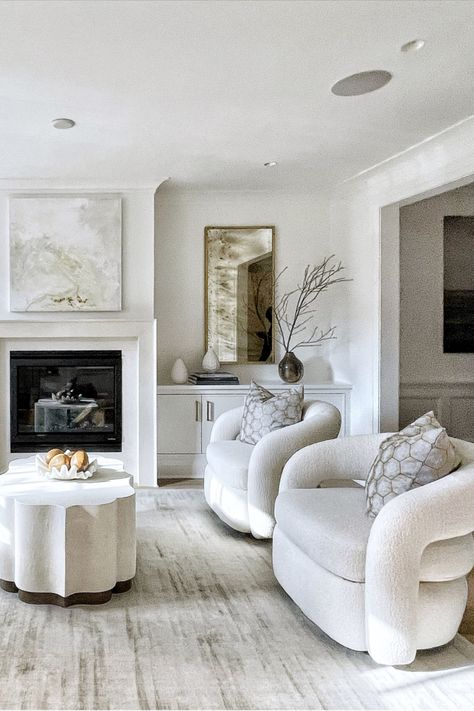 White colored living room with white chairs and large distressed rug. Coffee table is in center frame along with other home decor options in the background. Feizy Rugs, White Chairs, Unique Coffee Table, White Chair, Living Room Inspiration, Swivel Chair, Luxury Furniture, Alchemy, Home Decor Accessories