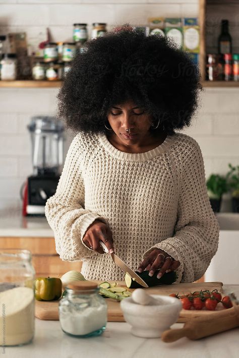 Beautiful black woman cooking in her home. Cooking concept. Cooking Aesthetic Girl Black, Cooking Reference Photo, Home Cook Photography, Cooking In The Kitchen Photography, Black Woman Journaling Aesthetic, Branding Photos In Kitchen, Black Girls Cooking Aesthetic, Person Cooking Drawing Reference, Home Cooking Photography