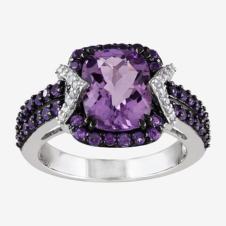 This genuine amethyst and diamond ring adds elegance to all your dressing decisions.Metal: Sterling silverStone: 10x8mm cushion-cut genuine amethystOther Stones: 1/10 ct. t.w. diamondsSetting: ProngDimensions: 23.1x13mm highCare: Wipe CleanCountry of Origin: ImportedGemstones may be treated and may require special care.Diamond total weights may vary between .01 and .08 carat.Jewelry photos are enlarged to show detail. Disclaimer: Metal may be rhodium plated to enhance appearance and reduce tarn… Sterling Silver Halo Ring, Silver Halo Ring, Amethyst And Diamond Ring, Purple Jewelry, Amethyst Jewelry, Art Deco Ring, Diamond Fashion, Halo Ring, Amethyst Ring